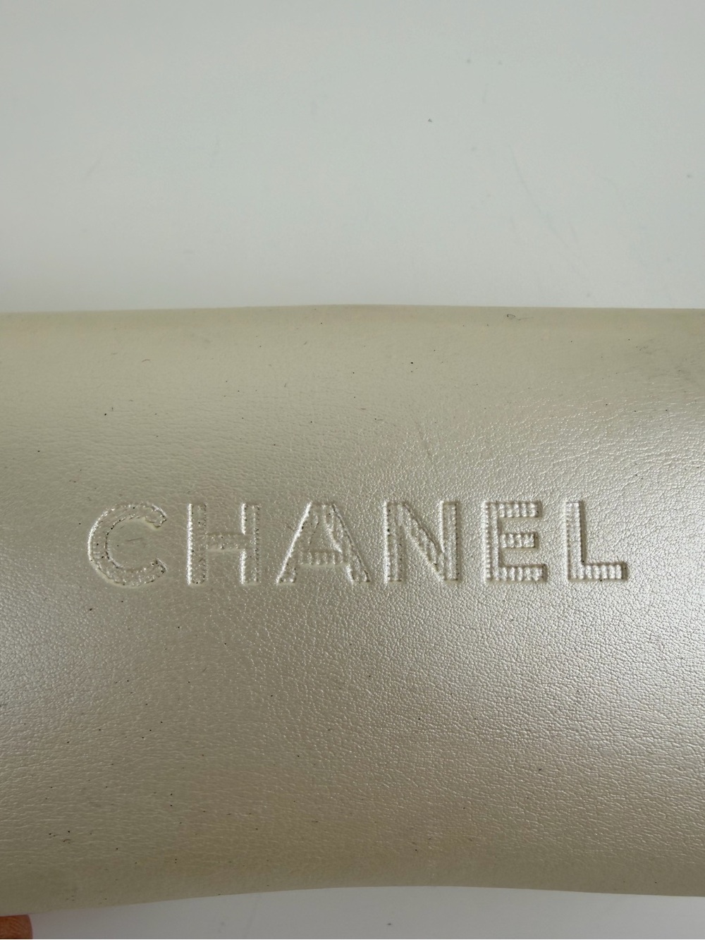 CHANEL Metallic Champagne Leather Logo Sleeve
